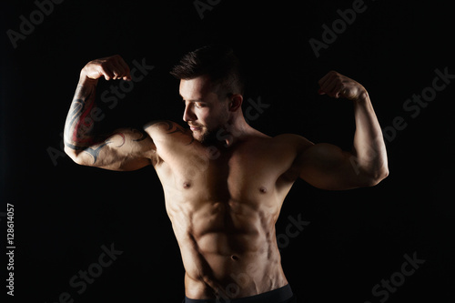 Strong athletic man showes naked muscular body © Prostock-studio