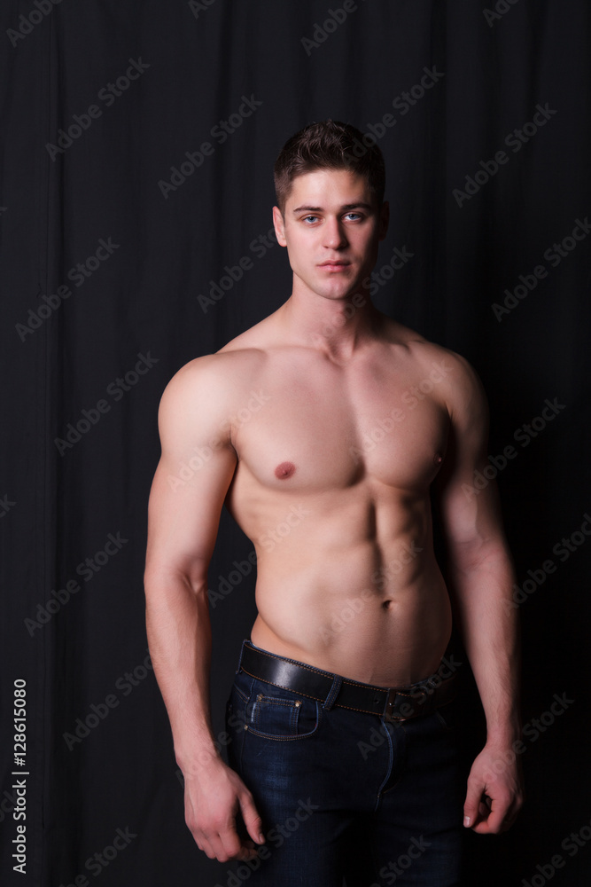sports guy with a naked torso on a black background