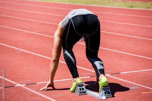 Athlete on a starting block about to run © WavebreakMediaMicro