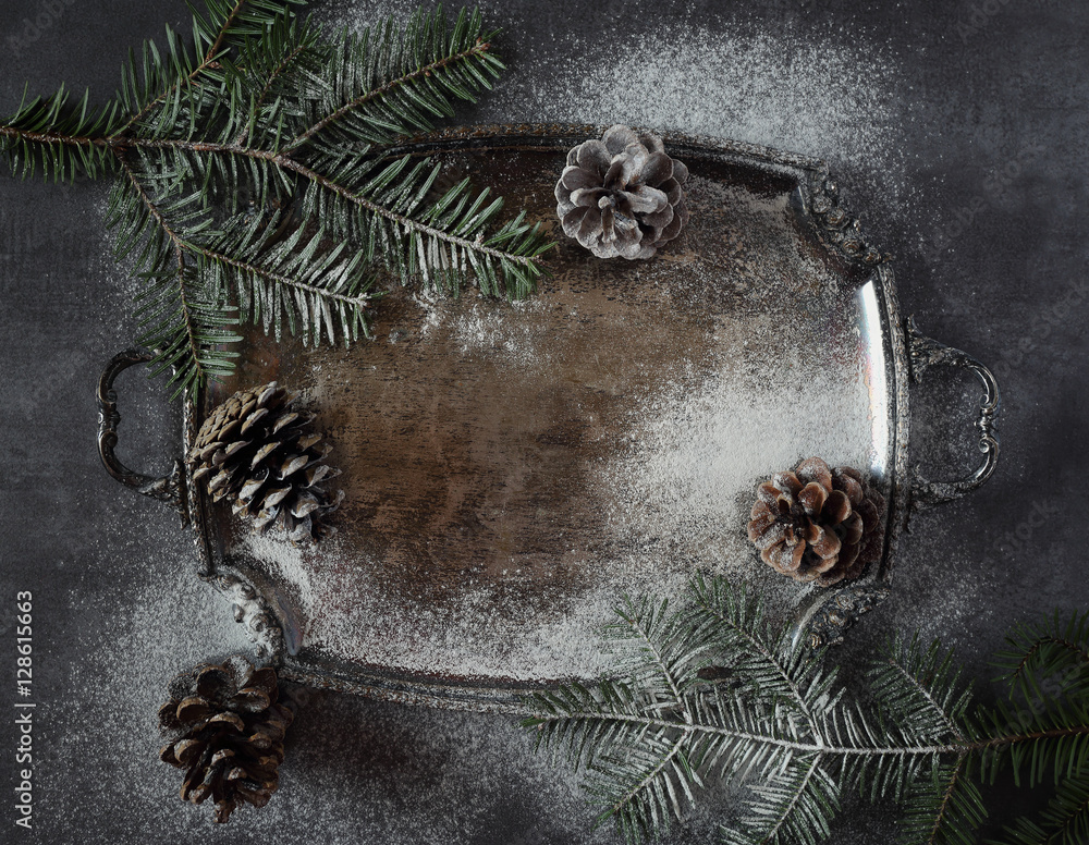 New Year background: pine cones and fir branches on vintage tray