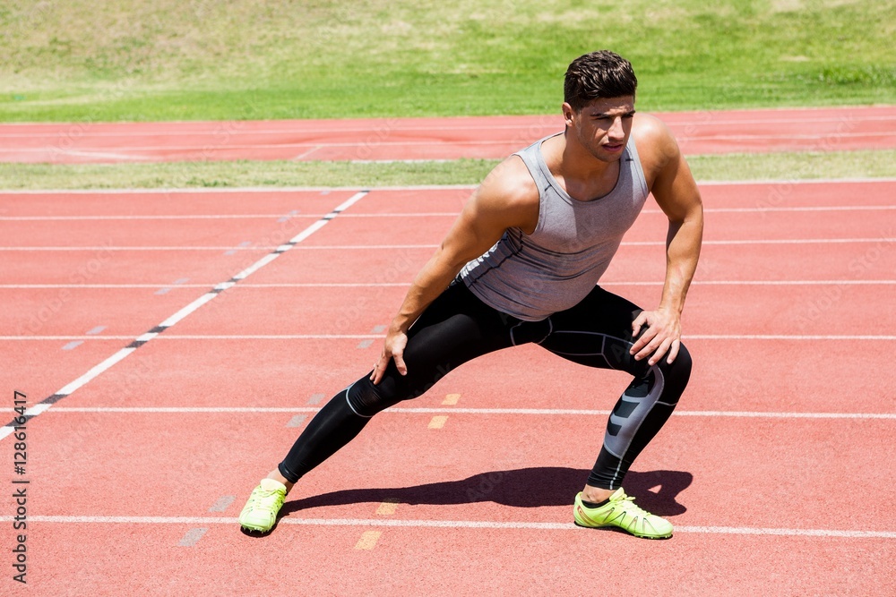 Obraz premium Athlete warming up on the running track