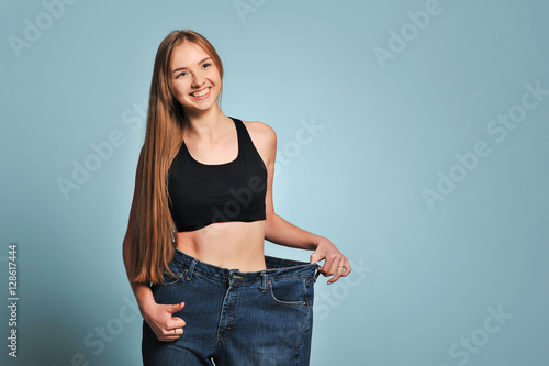 Women shows her weight loss.