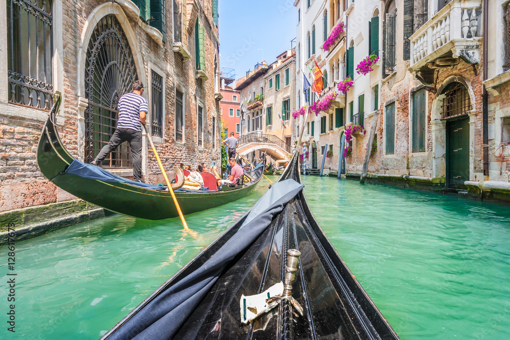 Naklejka premium Gondola ride through the canals of Venice, Italy