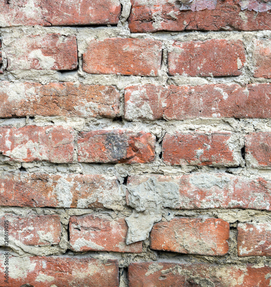 Fototapeta premium Red uneven brick wall backgroundold. Closeup square.