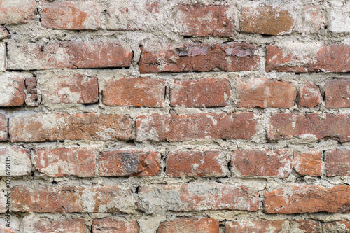 Red uneven brick wall backgroundold. Closeup horizontal