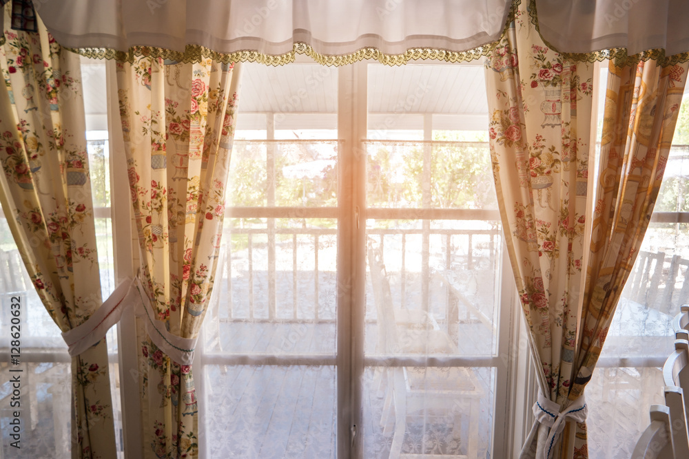 Window and curtains. Porch behind the window. Go meet the summer. Spend holidays at home. Window and curtains. Porch behind the window. Go meet the summer. Spend holidays at home.