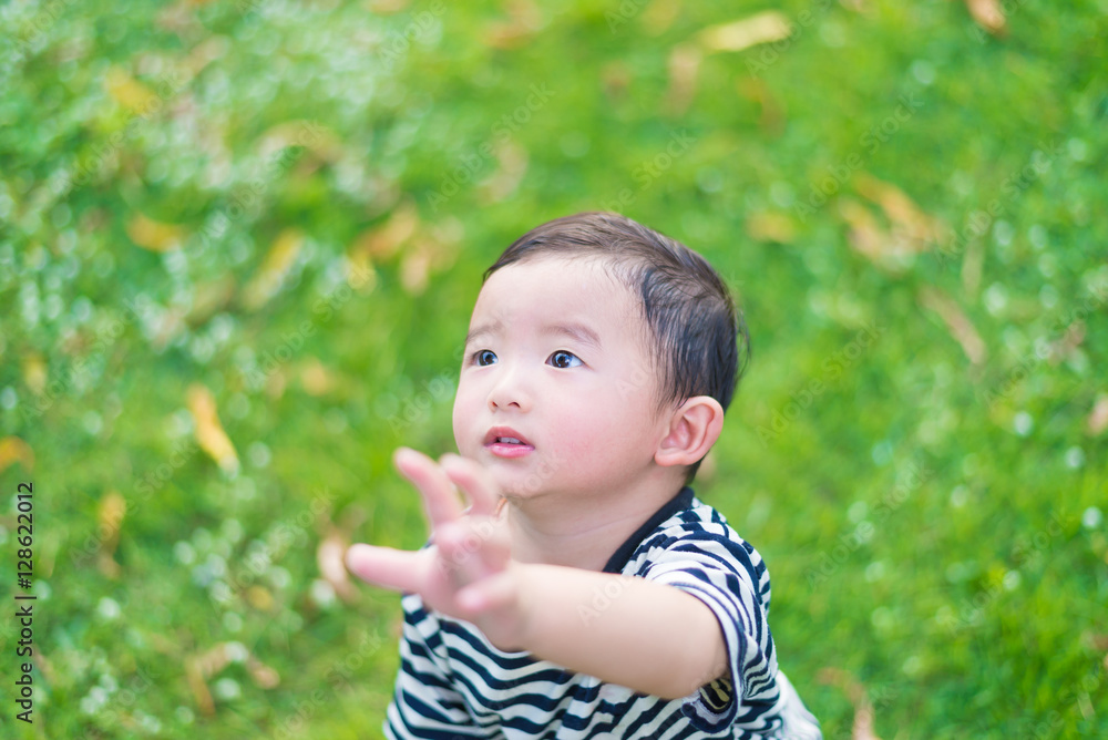 Close-up little Asian boy looking up somewhere and thinking with Close-up little Asian boy looking up somewhere and thinking with