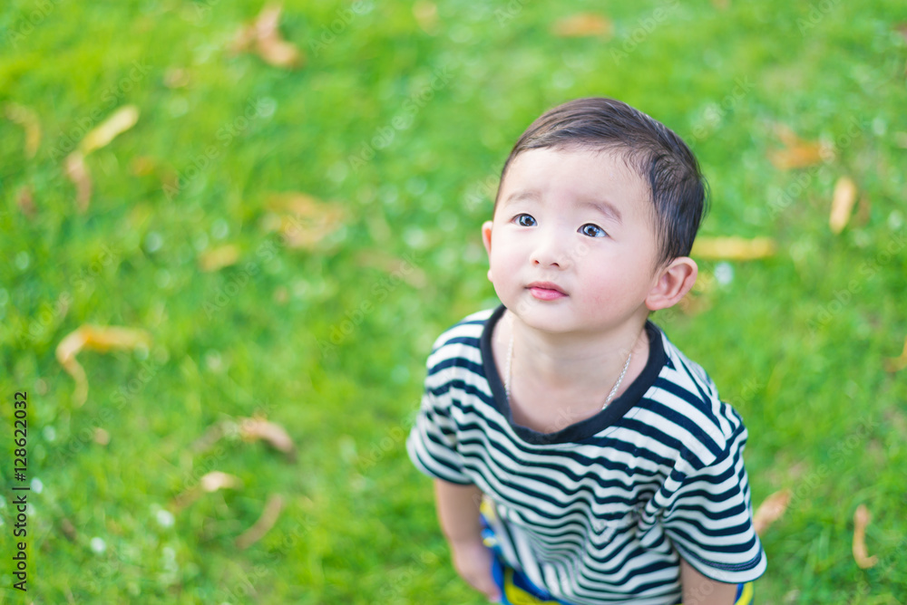 Close-up little Asian boy looking up somewhere and thinking with Close-up little Asian boy looking up somewhere and thinking with