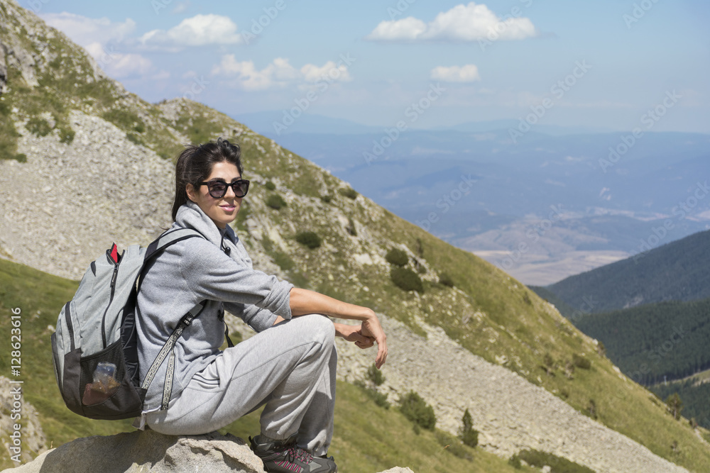 woman backpacker on a mountain peak
