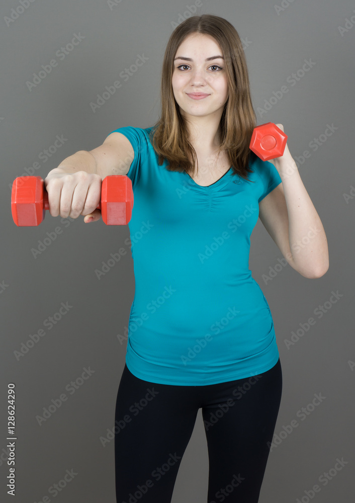girl with dumpbells on grey background sport concept gym girl with dumpbells on grey background sport concept gym
