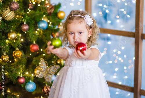 Little girl holding a Christmas toy