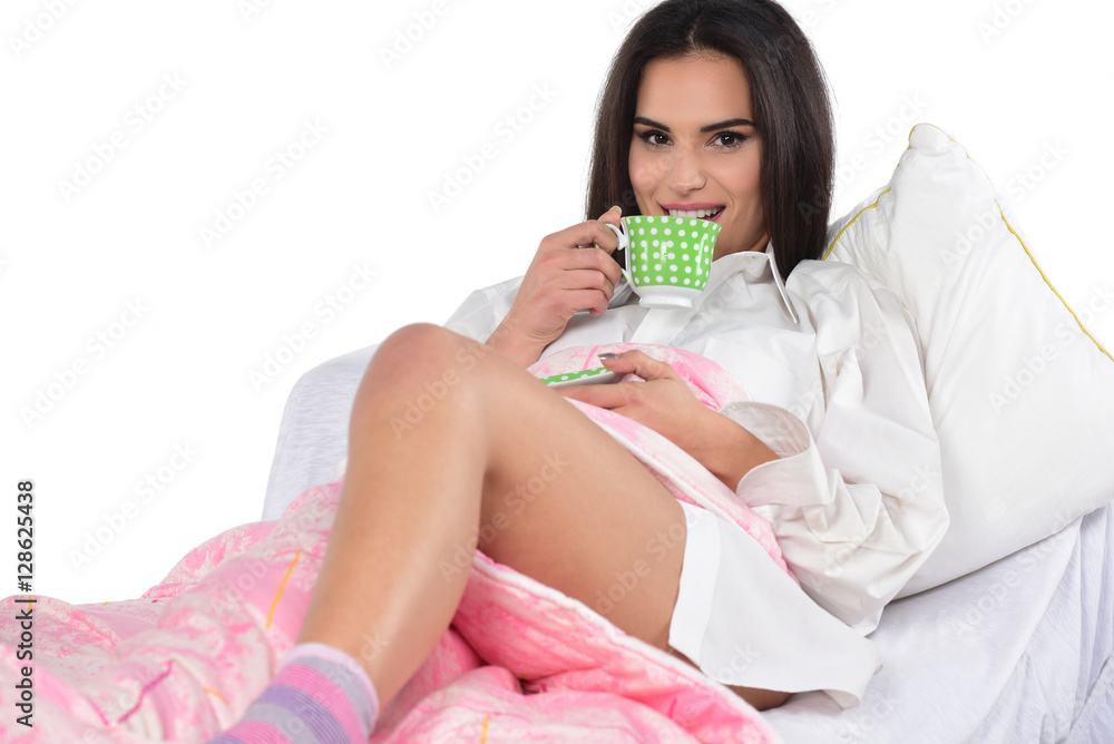 pretty smiling brunette in a white men's shirt holding cup of coffee pretty smiling brunette in a white men's shirt holding cup of coffee