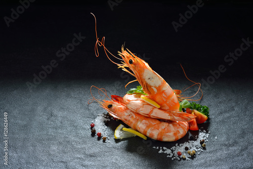 Cooked shrimps,prawns with seasonings on stone background photo