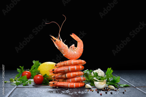 Cooked shrimps,prawns with seasonings on black background