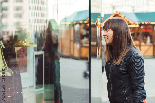 beautiful woman with shopping bags looking at the shop window