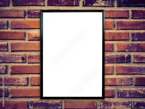 black poster frame on brick wall