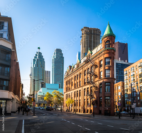 Gooderham or Flatiron Building in downtown Toronto with CN Tower on background - Toronto, Ontario, Canada