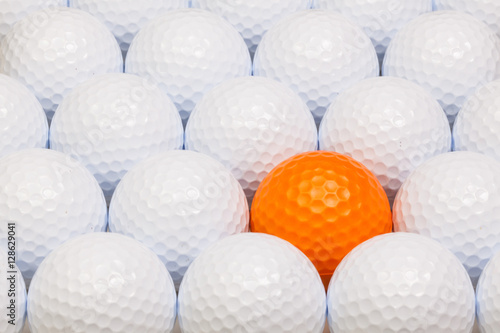 White and orange golf balls in the box