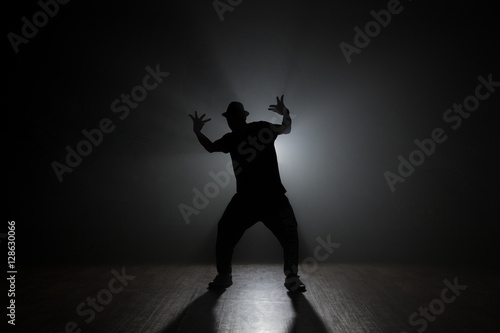 Dancer posing backlit.