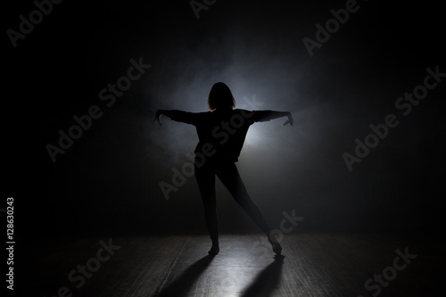 Dancer in studio with smooke on a dark background