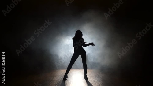 Sexy dancer in a smoke on a black background