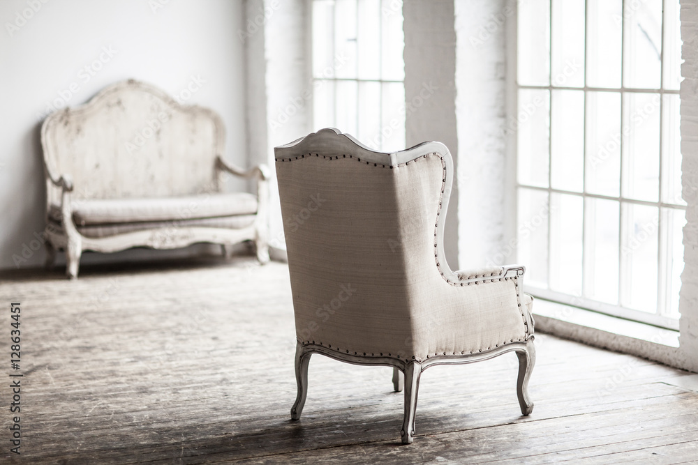 White textile classical style sofa in vintage room. White old ba