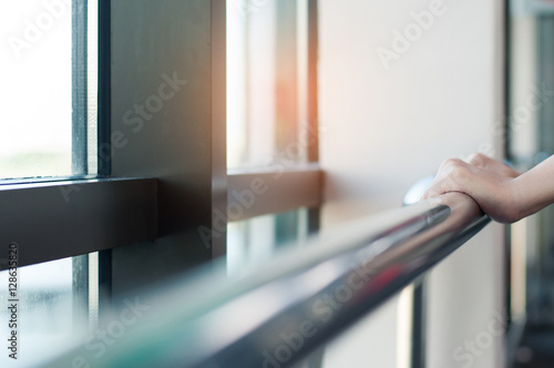 Close up of woman hands holding stainless  rail. photo