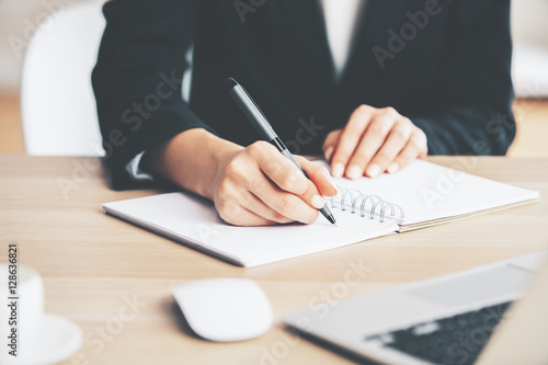 Girl writing in notepad