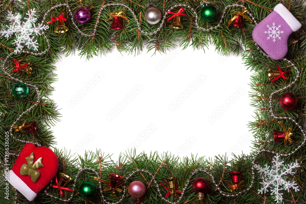 Christmas frame made of fir branches decorated with bells and balls isolated on white background Christmas frame made of fir branches decorated with bells and balls isolated on white background