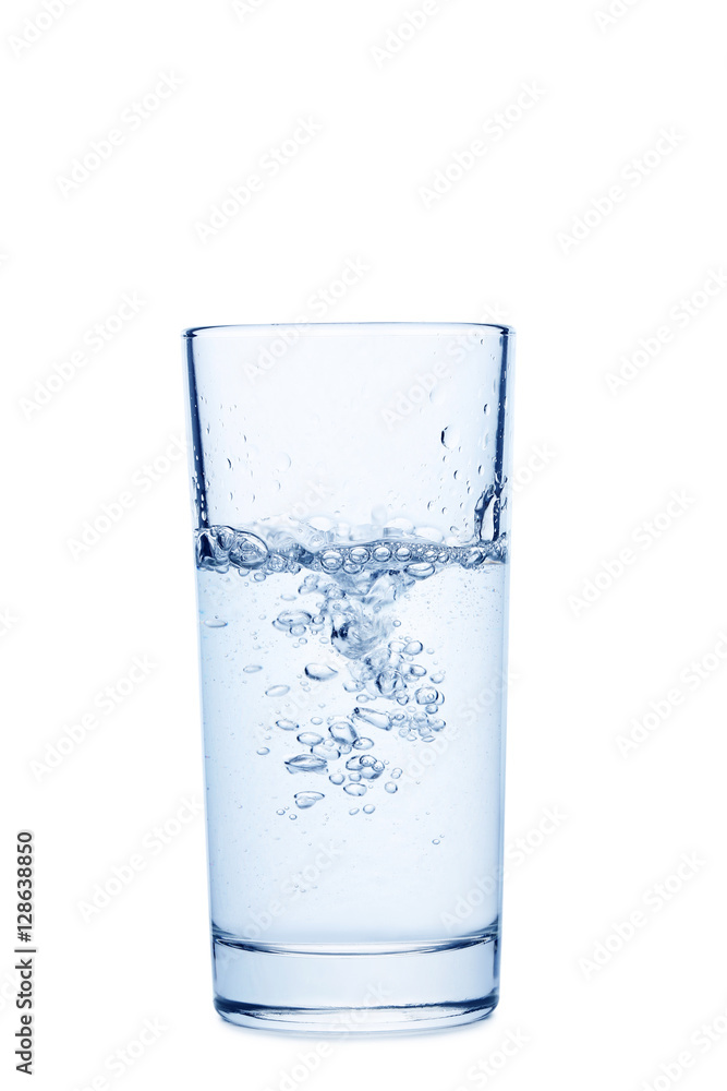 Water pouring in glass isolated on a white Water pouring in glass isolated on a white