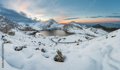 Covadonga lakes beautiful snowy winter landscape scene on a touristic location of Asturias, Spain, Europe, surrounded by mountains. Snow adventure leisure destination for holidays or vacations.