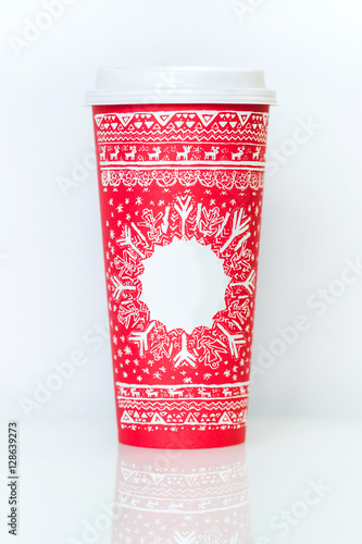 Paper coffee cup with red christmas pattern and empty place for