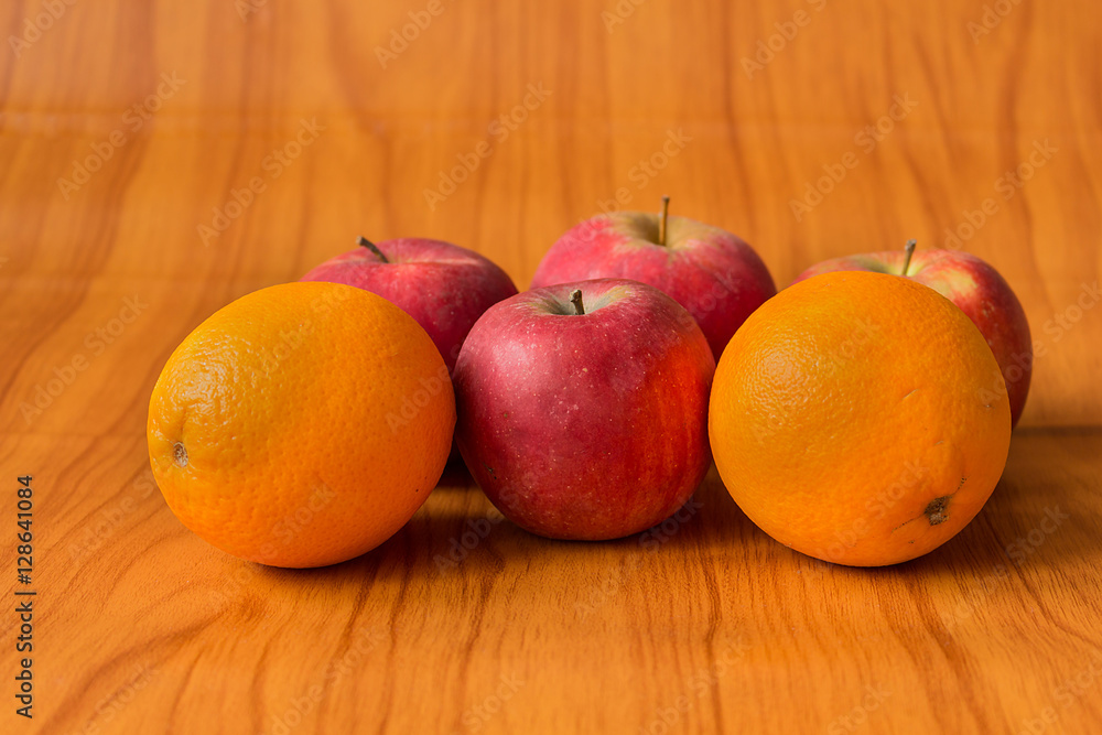 Apples and Oranges on brown background Apples and Oranges on brown background