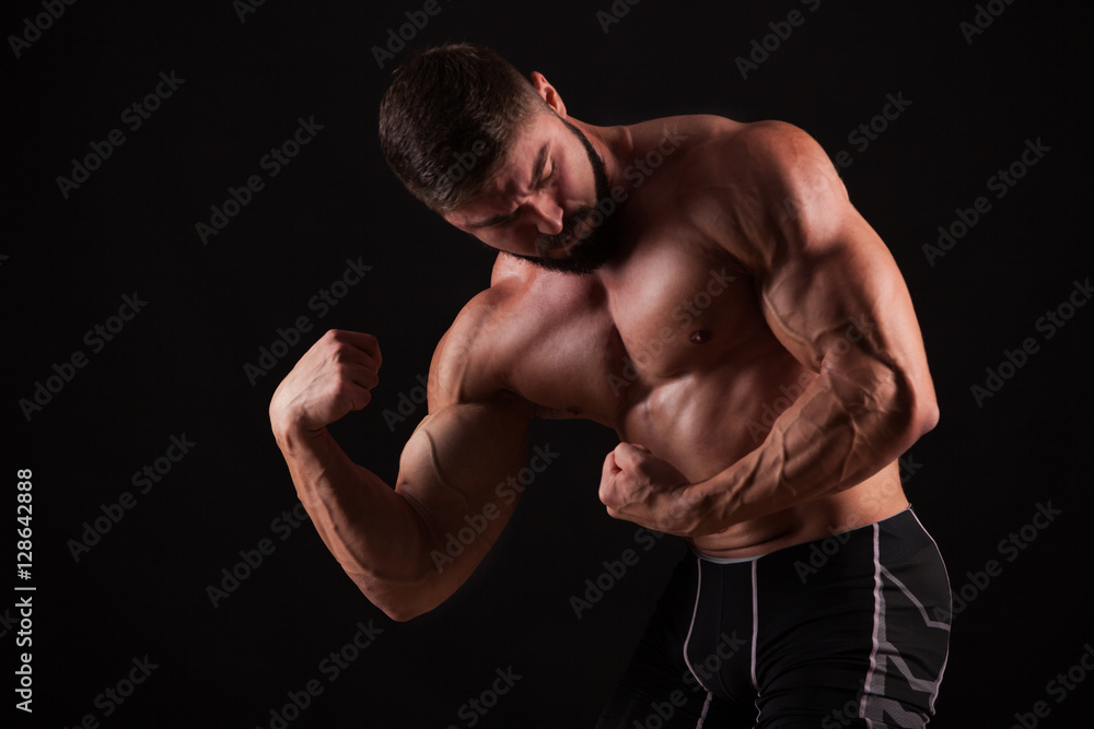 Close-up of a power fitness man's hand. Strong handsome young bodybuilder demonstrate his muscles and biceps