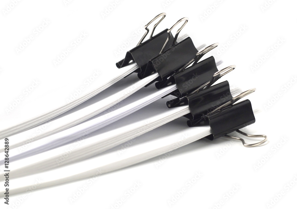 several stacks of paper held by binder clips, shallow depth of field several stacks of paper held by binder clips, shallow depth of field
