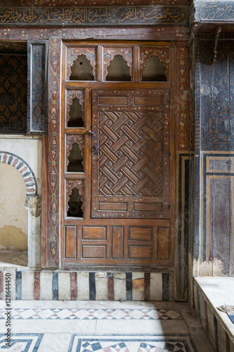 Embedded wooden ornate cupboard, in one of the rooms of El Sehemy house, an old Ottoman era house in Cairo, originally built in 1648 photo