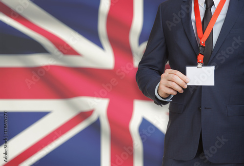 Wallpaper Mural Businessman holding name card badge on a lanyard with a national flag on background - United Kingdom Torontodigital.ca