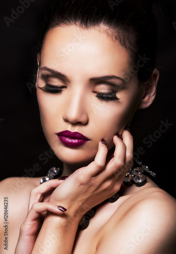 fashion woman with perfect skin wearing dramatic makeup