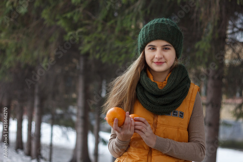 Beautiful girl on the nature in the winter outside in winter hat