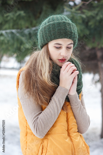 Beautiful girl on the nature in the winter outside in winter hat