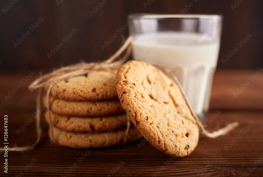 Cookies and milk. Chocolate chip cookies and a glass of milk. Vintage look. Tasty cookies and glass of milk on rustic wooden background. Food, junk-food, culinary, baking and eating concept