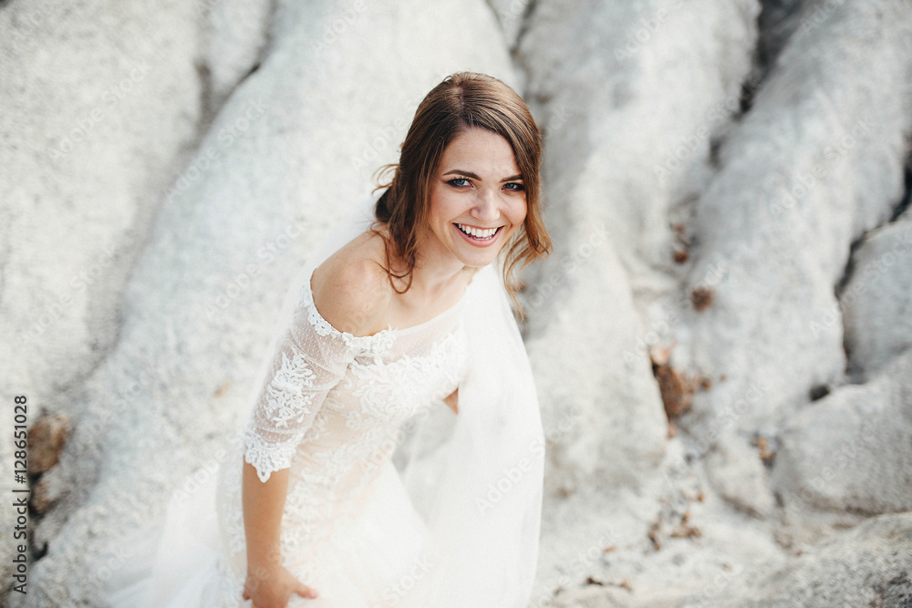 beautiful bride in a white dress walking on sand quarry beautiful bride in a white dress walking on sand quarry