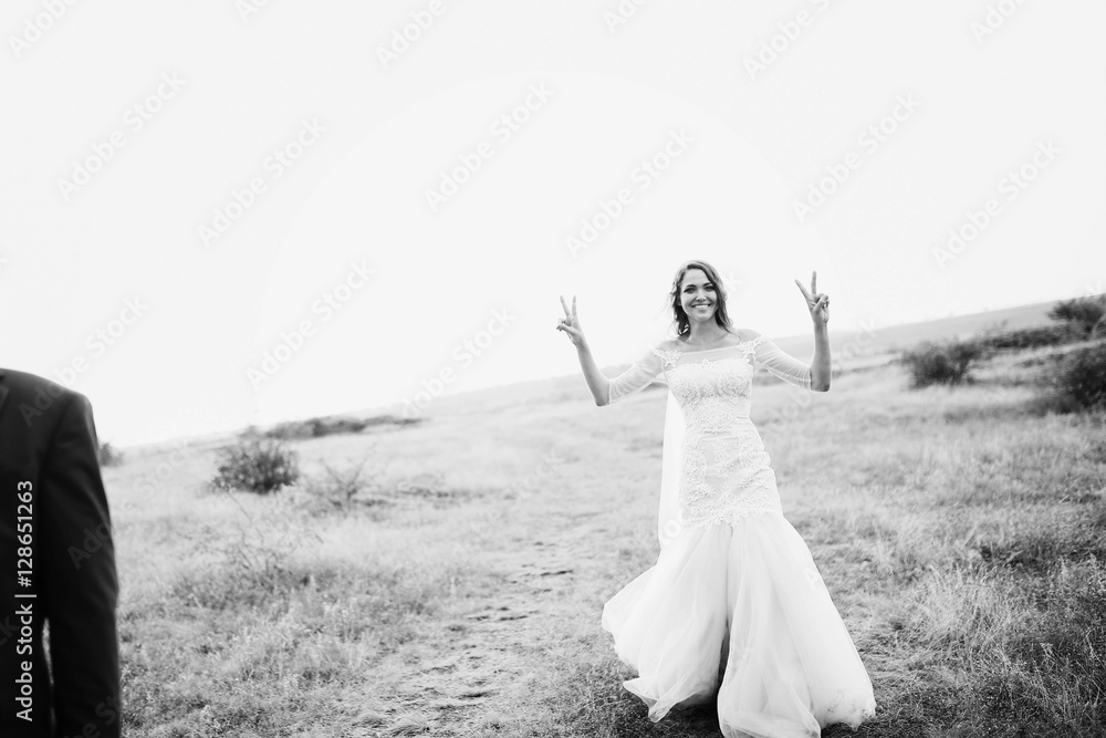 beautiful bride in a white dress walking on the field beautiful bride in a white dress walking on the field