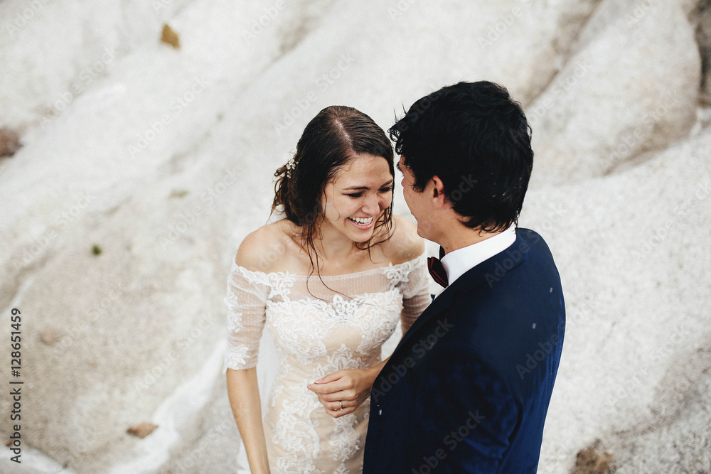 beautiful and happy groom and bride stands together outdoors beautiful and happy groom and bride stands together outdoors