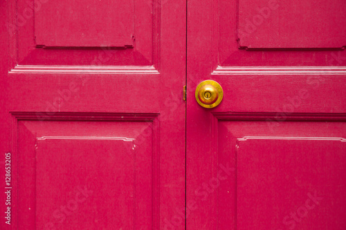 Door knob golden color with pink, door background
