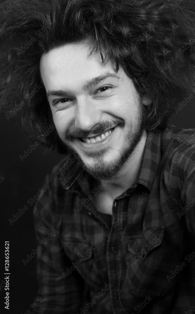 Fototapeta premium Portrait of a fashionable young man on dark background, chalkboa