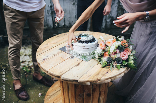 beautiful white cake standing on a wooden table