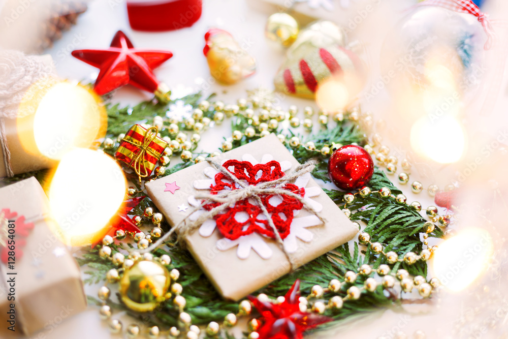 Christmas and New Year background with thuja branch, decorations and presents wrapped in craft paper with snowflakes. Christmas and New Year background with thuja branch, decorations and presents wrapped in craft paper with snowflakes.