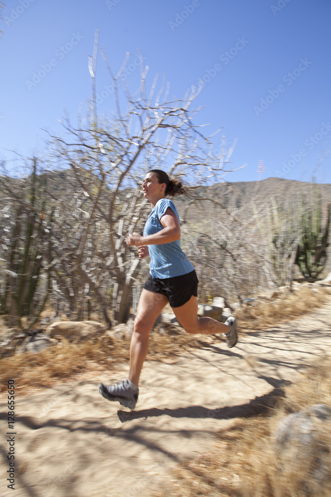 Adult woman running in dry hot desert near Cabo San Lucas, Baja California, Mexico Adult woman running in dry hot desert near Cabo San Lucas, Baja California, Mexico