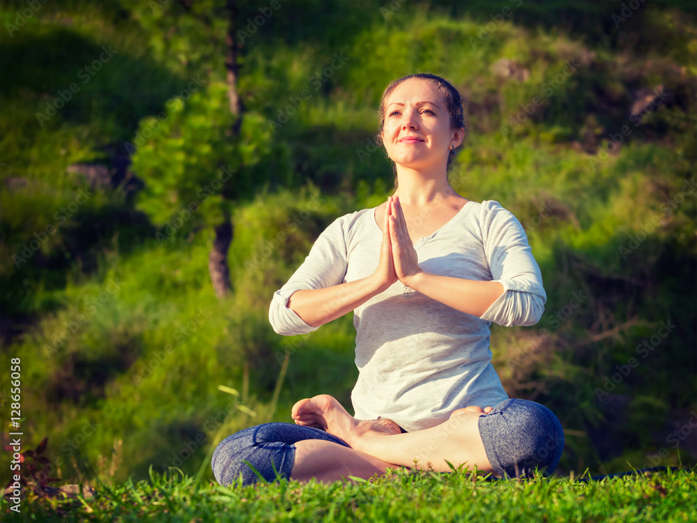Young sporty fit woman doing yoga Lotus pose oudoors Young sporty fit woman doing yoga Lotus pose oudoors